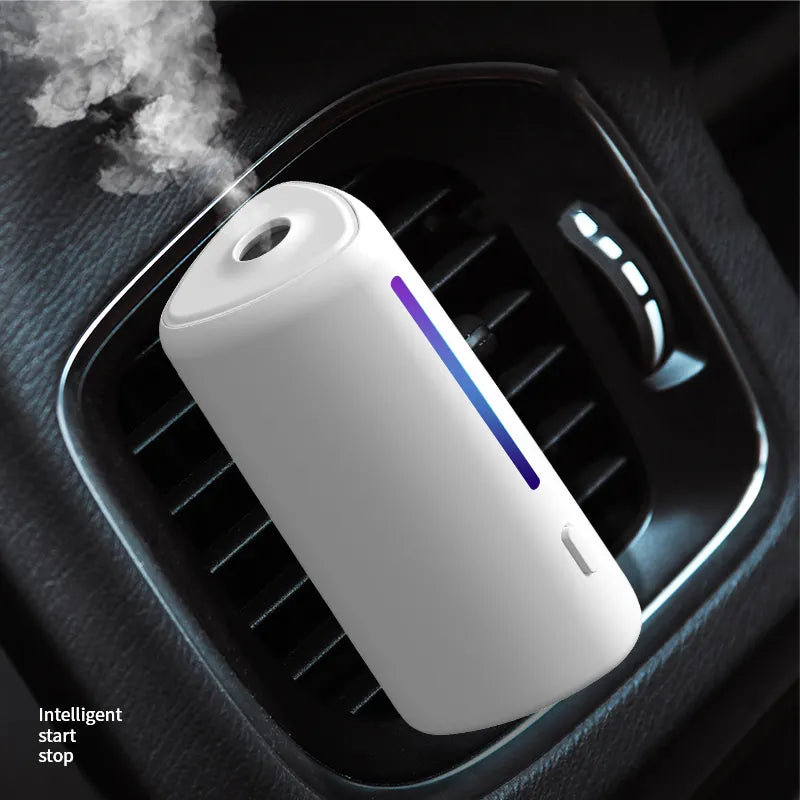 AuraMist Intelligent car aroma diffuser in a luxury vehicle cup holder emitting a fine cold mist.
